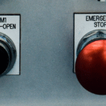 An emergency stop button next to a second button, representing a nonprofit’s chance to reset through a yearly organizational audit.