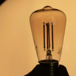 A glowing light bulb on a yellow background representing innovation and the evolving role of nonprofit leaders.