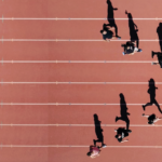 Marathon runners sprinting to the finish line representing a 30-day board fundraising push