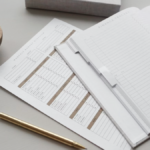 Desk with budgeting documents, pen, and paperclips, representing mission-driven financial planning.
