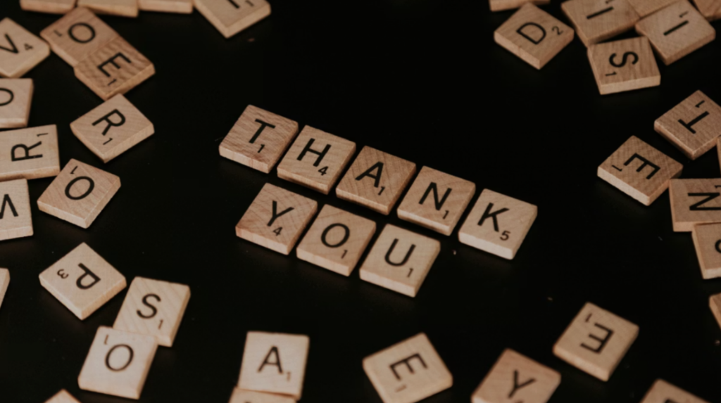 Scrabble tiles spelling “thank you,” representing nonprofit donor appreciation and stronger thank-you letters for donor stewardship.