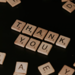 Scrabble tiles spelling “thank you,” representing nonprofit donor appreciation and stronger thank-you letters for donor stewardship.