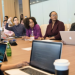 Nonprofit board members meeting in a conference room discussing strategy and governance during a board meeting.