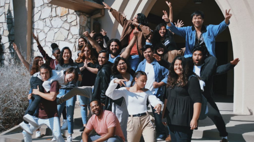 Group of nonprofit volunteers cheering together outside a building, representing strong volunteer engagement and retention in a community program.