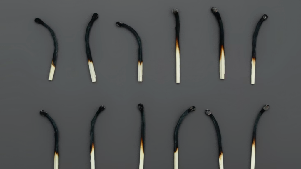 Two rows of six burned matches illustrating overwork and burnout