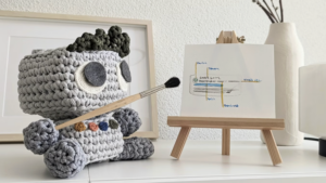 Toy stuffed robot pointing at a chart illustrating team workflow and efficiency improvement tips