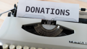 Typewriter with a sheet of paper showing the word “donations,” representing donor cultivation strategies to increase giving.