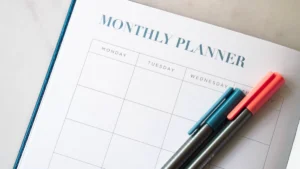 Open monthly planner book with pens laid on top, ready for nonprofit annual giving calendar planning
