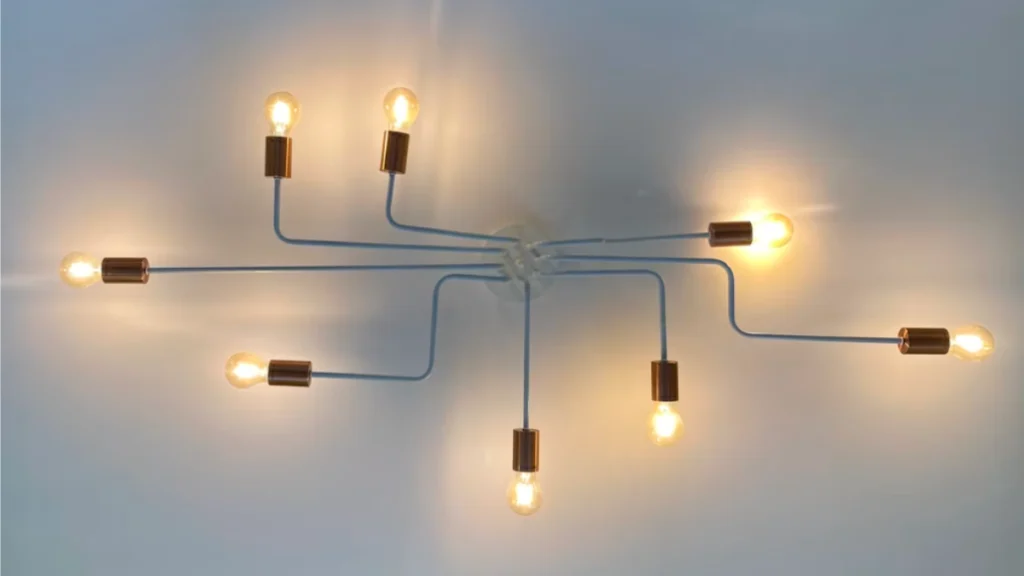 Hanging light fixture with bulbs angled outward in many different directions representing donor stewardship.